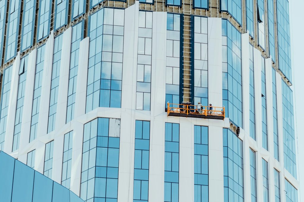 Professional high rise window cleaning service workers in gondola.